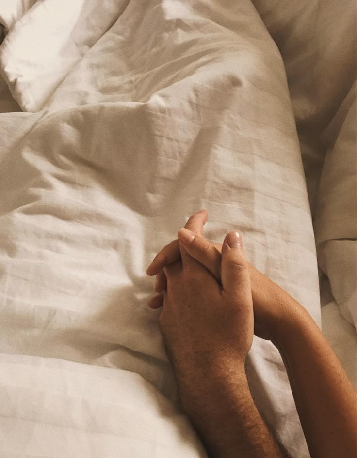 how to spice up your sex life couple holding hands in bed