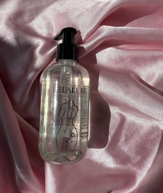 Lulalube water-based lubricant for sensitive skin displayed on pink silk fabric