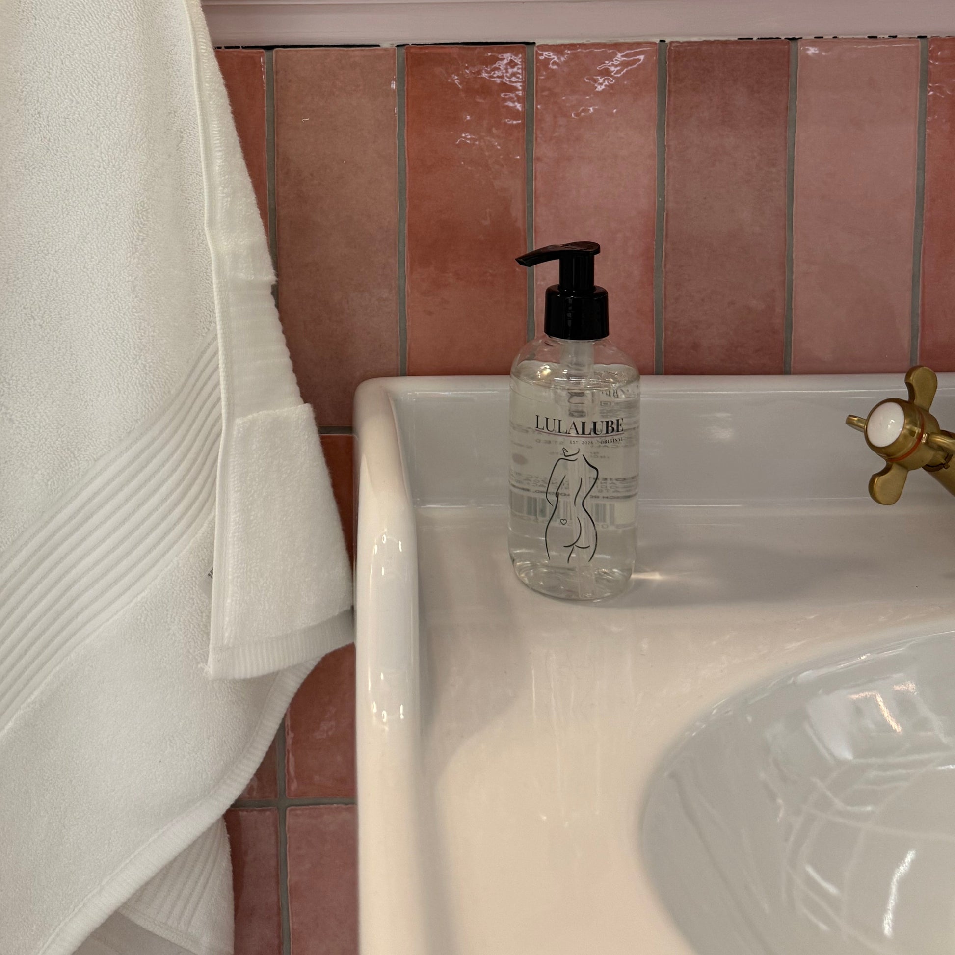 White towel draped over a sink in a bathroom setting