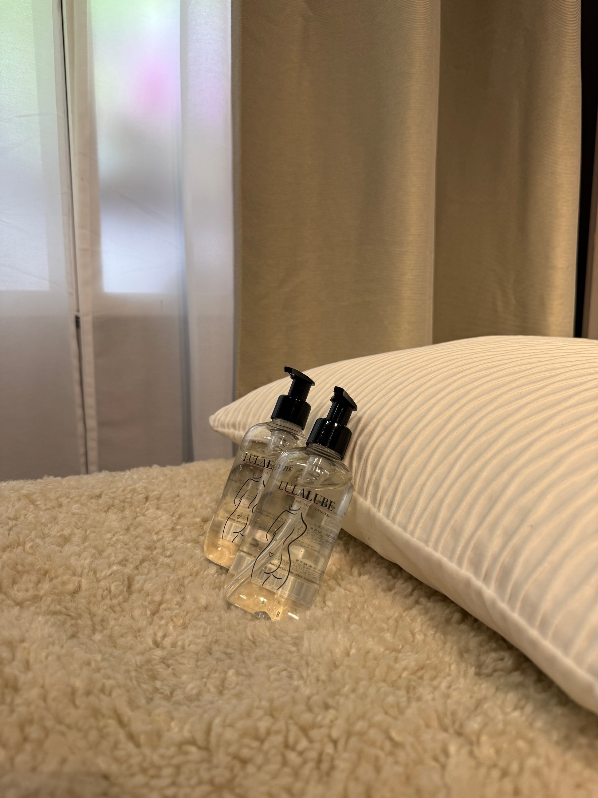 Water based lubricant sat on a bed near w window