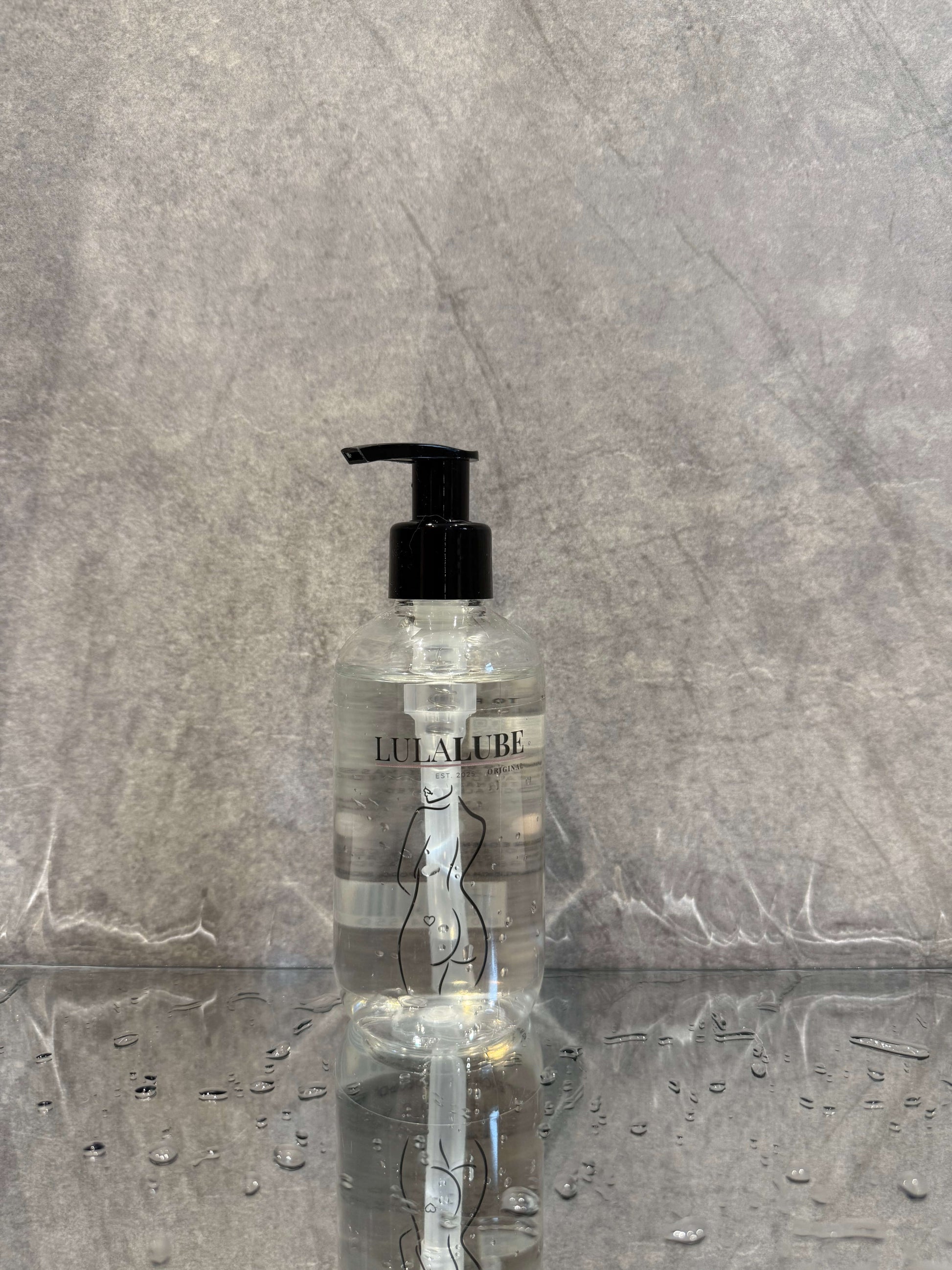 bottle of water based lubricant on a refelctive surface ready for anal