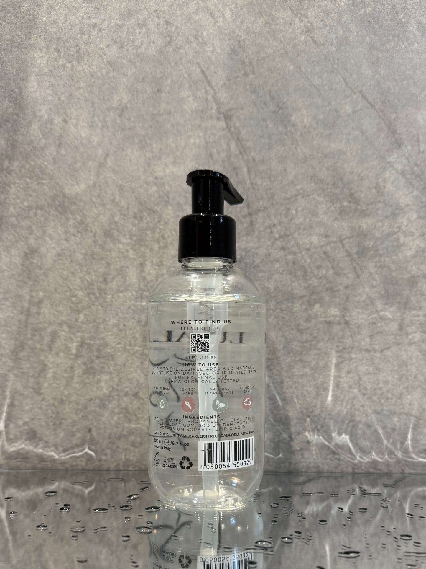 Clear bottle with black pump on a gray surface