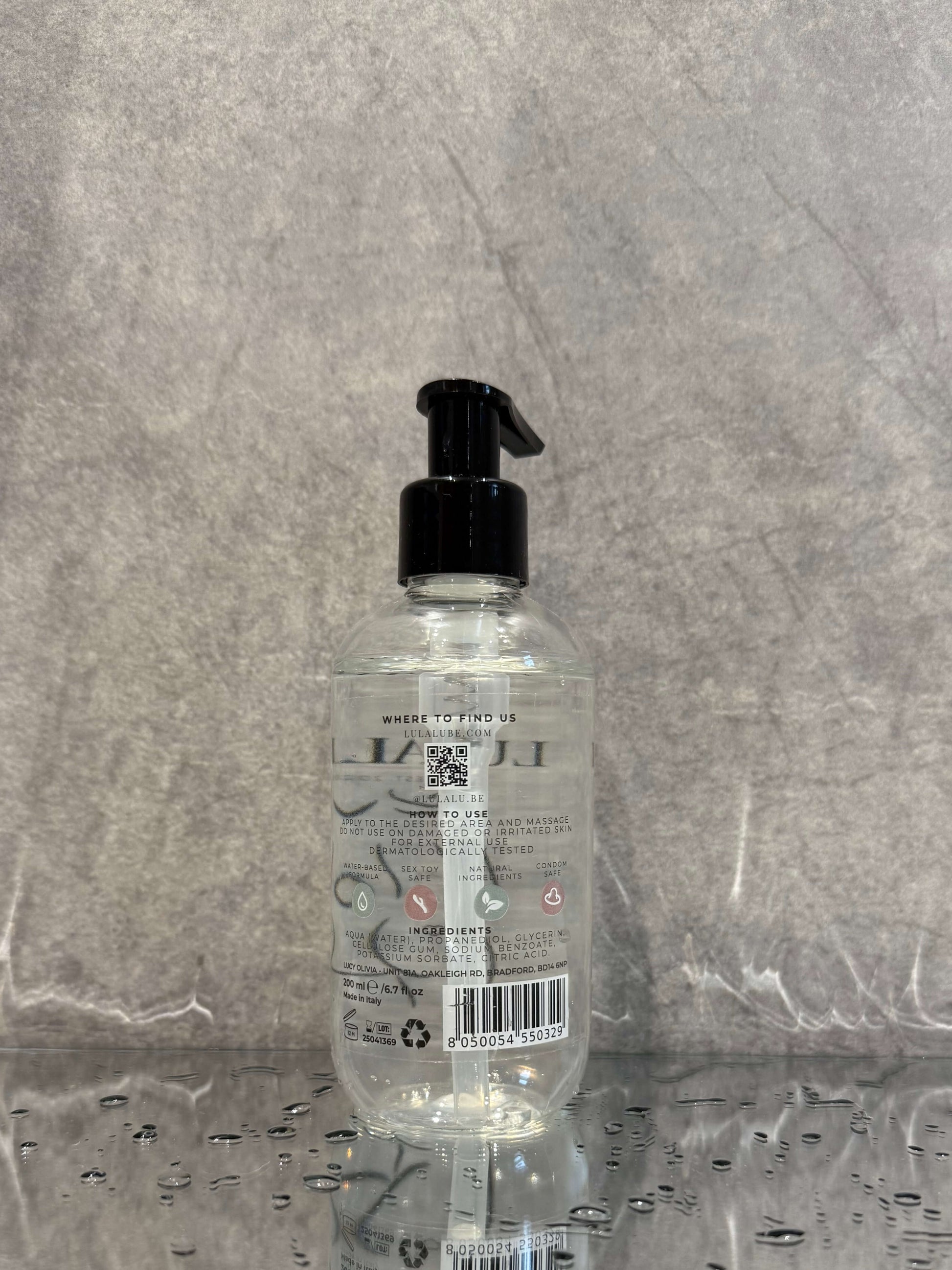 Clear bottle with black pump on a gray surface